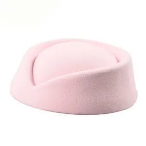 Detailed macro view of a vintage pink pillbox stewardess hat with soft wool texture