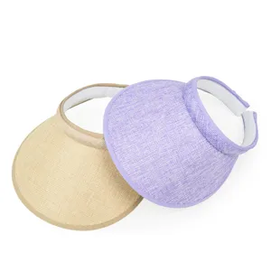 Detailed view of two summer empty top sun visor hats in beige and purple linen