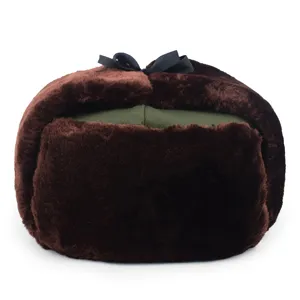 Detailed macro view of a brown faux fur winter ushanka hat with a decorative black bow
