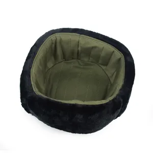 Interior detail of a warm black winter hat showing the army green quilted lining texture.