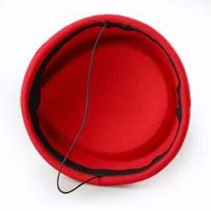 Inner view of a red stewardess pillbox hat with black elastic chin strap