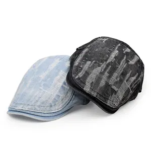 Distressed vintage denim flat caps in light blue and black with frayed rip details