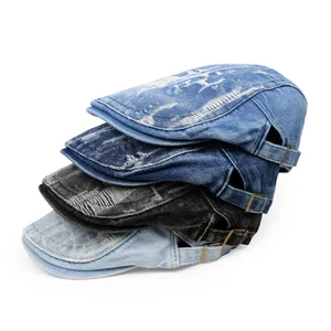 Detail showing a stack of distressed denim berets in light to dark blue and black colors