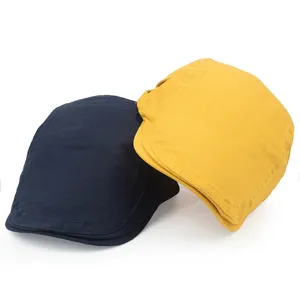 Detailed view of navy and yellow cotton flat caps with vintage British style