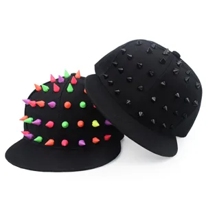 Two black hip-hop snapback hats with colorful and black plastic spikes in detail