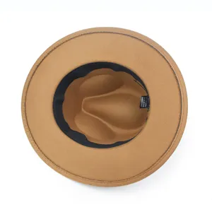 Interior view of brown felt fedora hat with black sweatband and care label