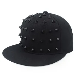 Close-up detail of black hip-hop snapback hat with decorative punk spikes