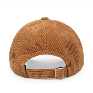 Detailed back view of a brown corduroy baseball cap showing the adjustable metal buckle