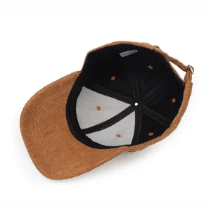Close-up interior view of brown corduroy baseball cap showing lining and care label