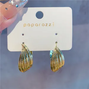 Elegant gold multi-layered textured hoop earrings shown in detail on a white card