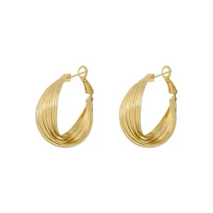 Detailed view of layered gold-tone hoop earrings with elegant twisted texture design