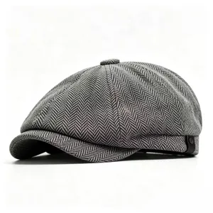 Detailed view of a classic grey herringbone newsboy cap with vintage octagonal design