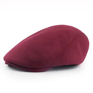 Close-up of a burgundy knitted ivy cap showing its soft texture and retro design.