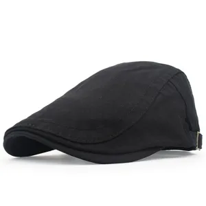 Close-up side view detail of a classic black cotton flat cap with an adjustable metal buckle