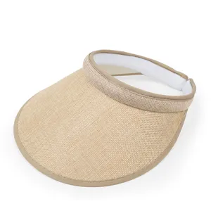 Detail shot of a natural beige sun visor hat with woven linen texture and khaki trim