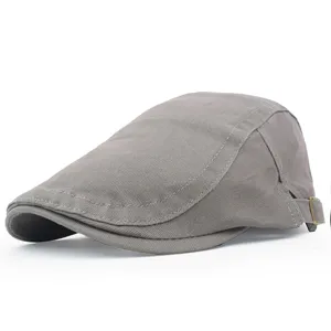 Close-up side view of a classic grey cotton twill flat cap featuring an adjustable metal buckle