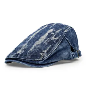 Detailed side view of a vintage distressed blue denim flat cap with ripped texture