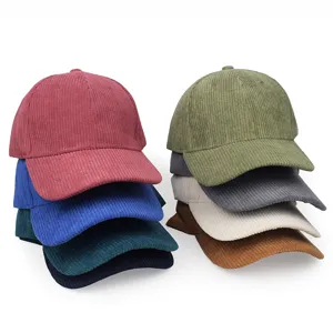Stack of colorful corduroy baseball caps showing various solid colors and texture