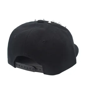 Detail view of a black snapback hat featuring silver punk rivets on the top crown