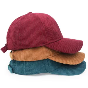 Detail view showing the corduroy texture and multiple colors of the baseball caps