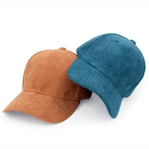 Detailed macro view of brown and teal blue corduroy baseball caps showing ribbed texture