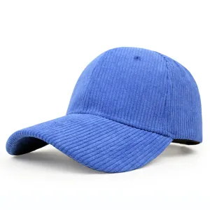 Close-up detail of a vibrant blue corduroy baseball cap featuring a classic curved brim.