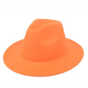 Detailed view of vibrant orange felt fedora hat featuring a classic jazz style crown