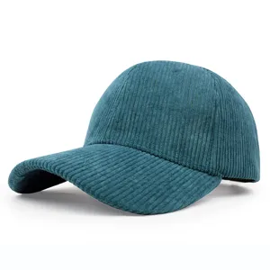 Detailed view of the teal blue corduroy texture on a curved brim baseball cap.