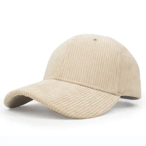 Detail view of the beige corduroy baseball cap showing the vertical ribbed fabric texture