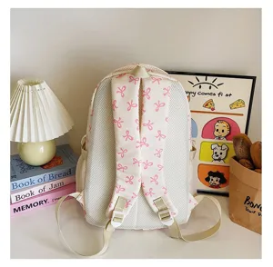 Detail of back straps on creamy white ins-style backpack with pink bow patterns for students