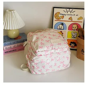 Close-up of a white college backpack with pink bow pattern and Hello weekend patch