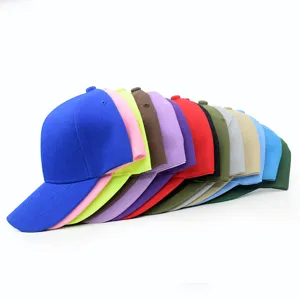 Detailed macro view showing a collection of colorful plain baseball caps with curved brims