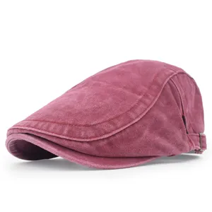 Close-up side view of a vintage washed red cotton newsboy beret with adjustable buckle