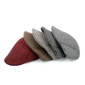 Close-up detail of vintage houndstooth woolen flat caps in multiple classic colors