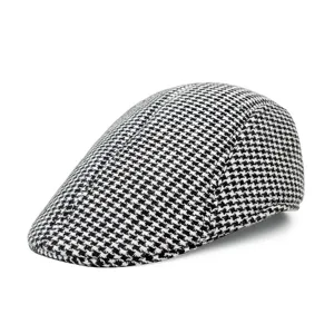 Detailed side view showing houndstooth wool fabric texture of a classic flat cap