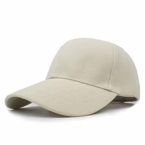 Detail view of the beige solid color baseball cap with curved brim and twill texture