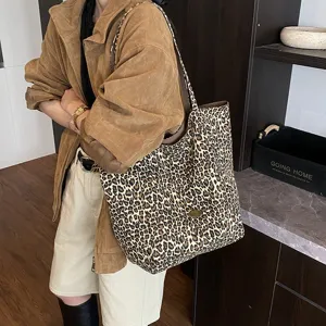 Fashionable leopard print canvas tote bag shown in a lifestyle street style context