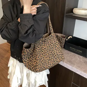 Detail view of a large leopard print canvas tote bag styled with casual outfit