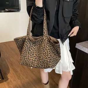 Large leopard print canvas tote bag carried by model in casual outfit