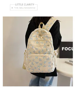 Close-up view of the large capacity student backpack with a cute blue bow pattern print