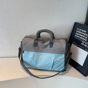 Large capacity grey and blue sports travel duffel bag with shoulder strap