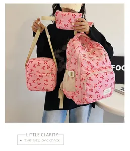 Detailed display of the pink three-piece backpack set featuring trendy red bow patterns