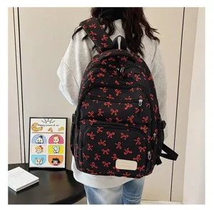 Back view of a trendy black backpack with red bow patterns, casual style for students.