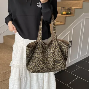 Large capacity leopard print canvas tote bag shown being carried by a person in a casual setting