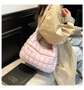 Large pink quilted puffer shoulder bag featuring cloud texture and zipper closure