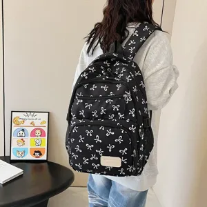 Fashionable large capacity black backpack for women with cute white bow patterns