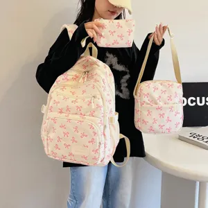 Stylish three-piece cream backpack set featuring pink bow patterns for female students
