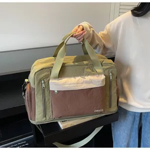 Close-up of a large olive green and brown gym bag featuring dry wet separation design