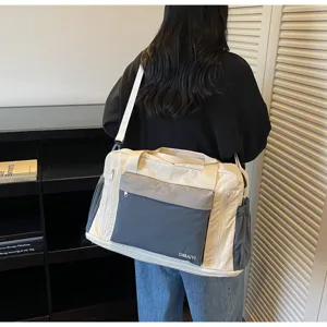 Large cream and grey dry-wet separation travel bag worn by a person, detail back view.