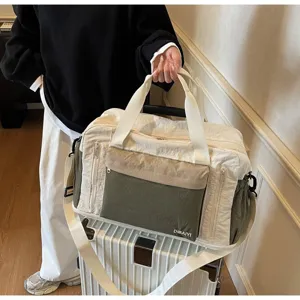 Large capacity wet dry separation sports gym bag shown on a white suitcase during travel